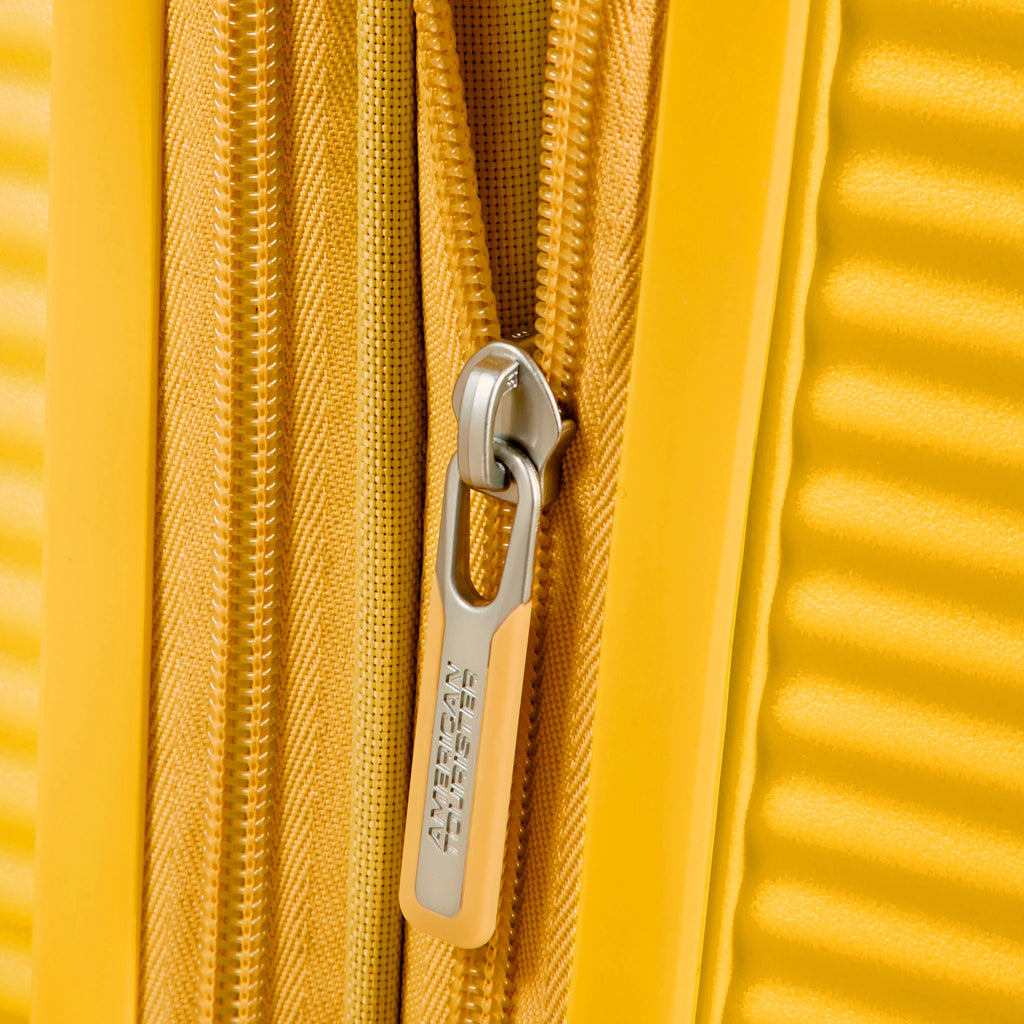 American Tourister Curio Spinner Medium in the color Golden Yellow.