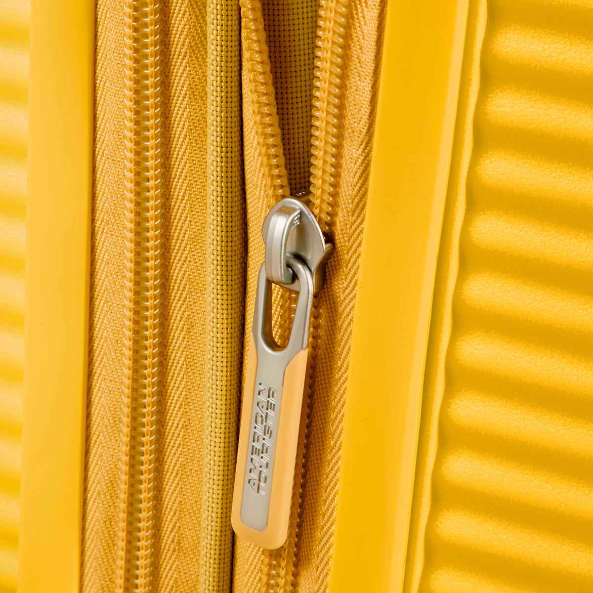 American Tourister Curio Spinner Medium in the color Golden Yellow.